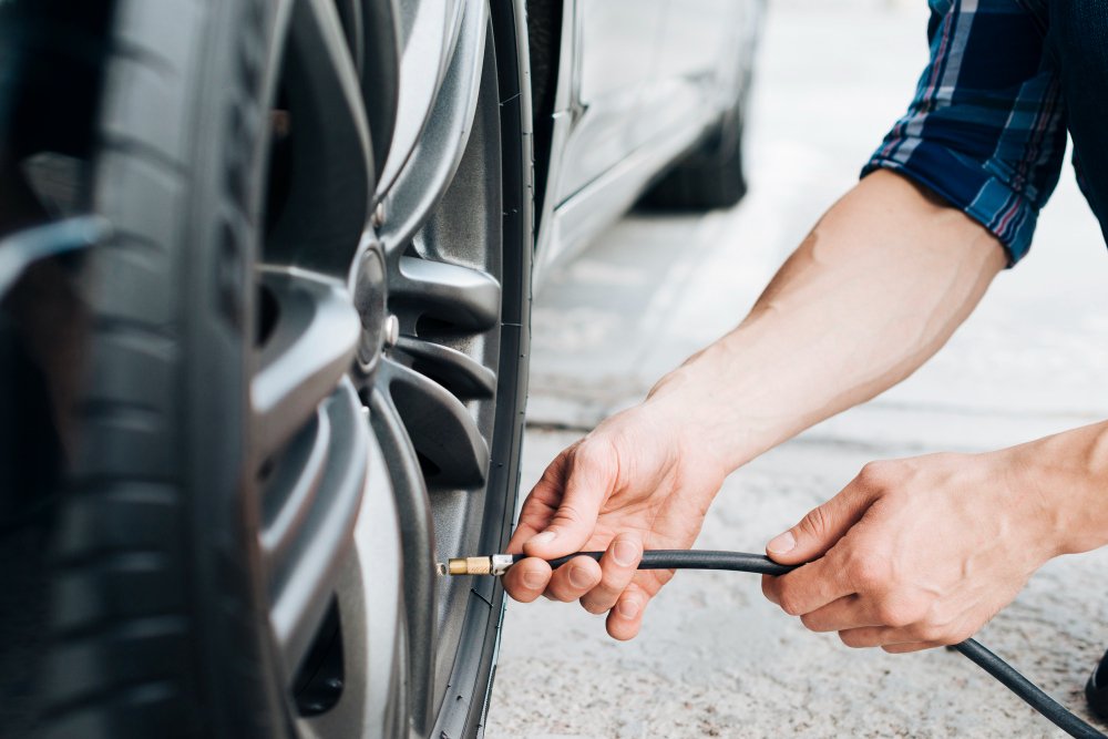 Technician checking tyre pressure