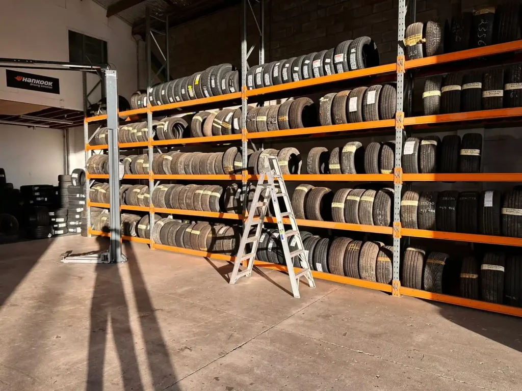 Shelves stocked with tyres in a warehouse